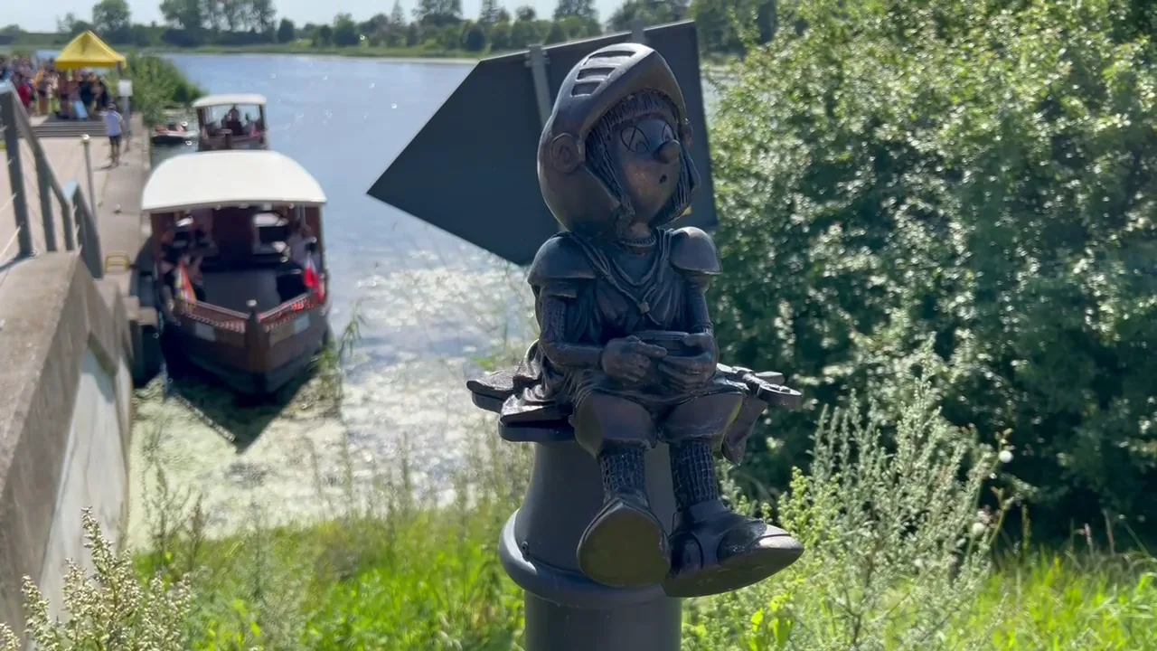 Little bronze Marianek knight sculpture by the river